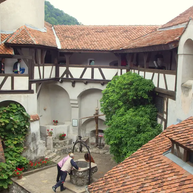 The inner courtyard of Bran Castle with its timber galleries and well